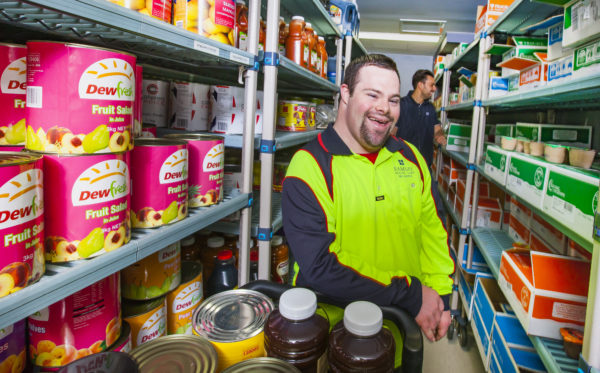 Christopher laughing while in his works storeroom