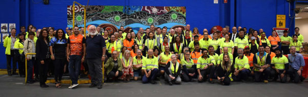 Perth Parcel Centre staff and guests with Bynder in front of the new mural
