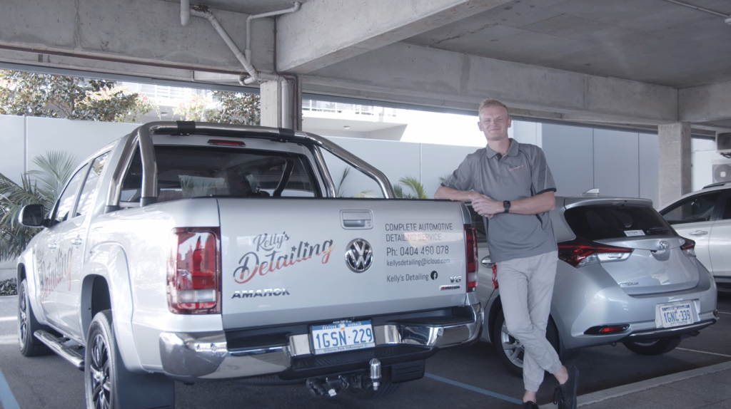 Ben leaning against his work ute