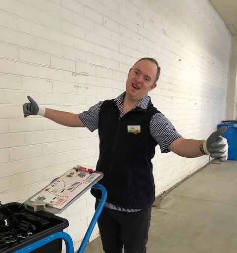 Greg giving the thumbs up at work