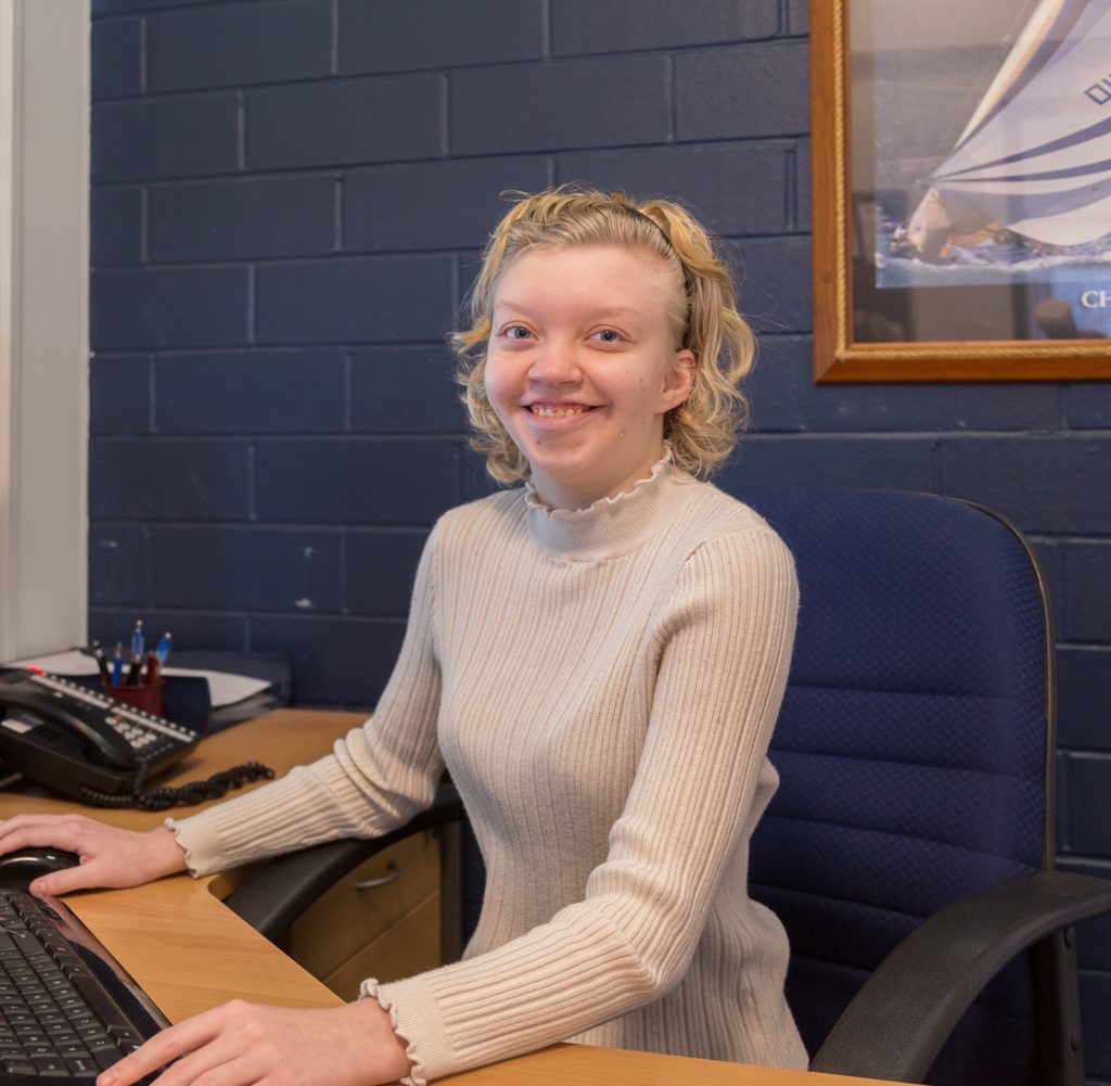 Tayla sitting at her desk