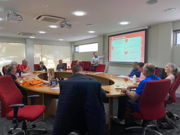 Group of people sitting around the Edge boardroom table