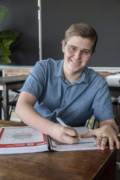 Anthony smiling while writing