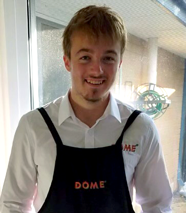 Jamie wearing his Dome apron and smiling.
