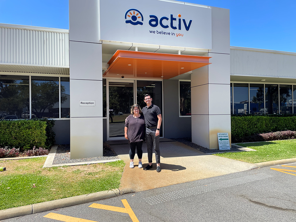 Tina and Zack standing together outside the Activ Foundation building.