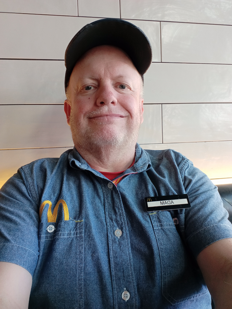 Selfie of Adam smiling in his McDonald's work uniform.