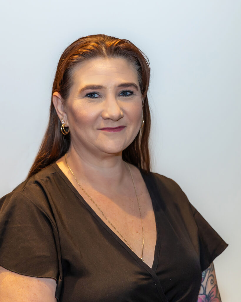 Head shot image of Karen. She is wearing a black t-shirt.