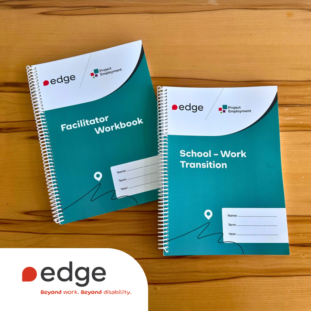 Two Edge Project Employment workbooks, including a Facilitator Workbook and a School–Work Transition workbook, displayed on a wooden table. Both feature the Edge and Project Employment logos with teal and white covers.